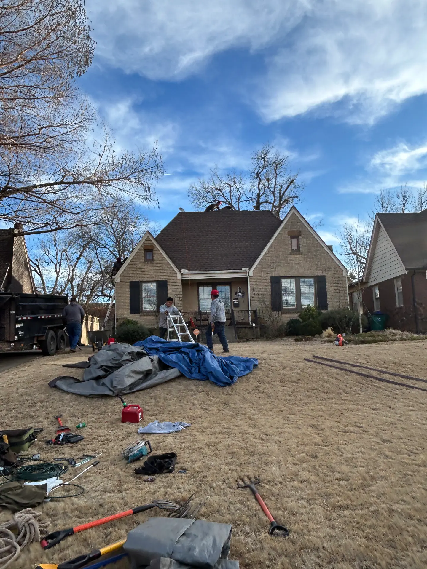Tarps laid out in the yard during a tear off