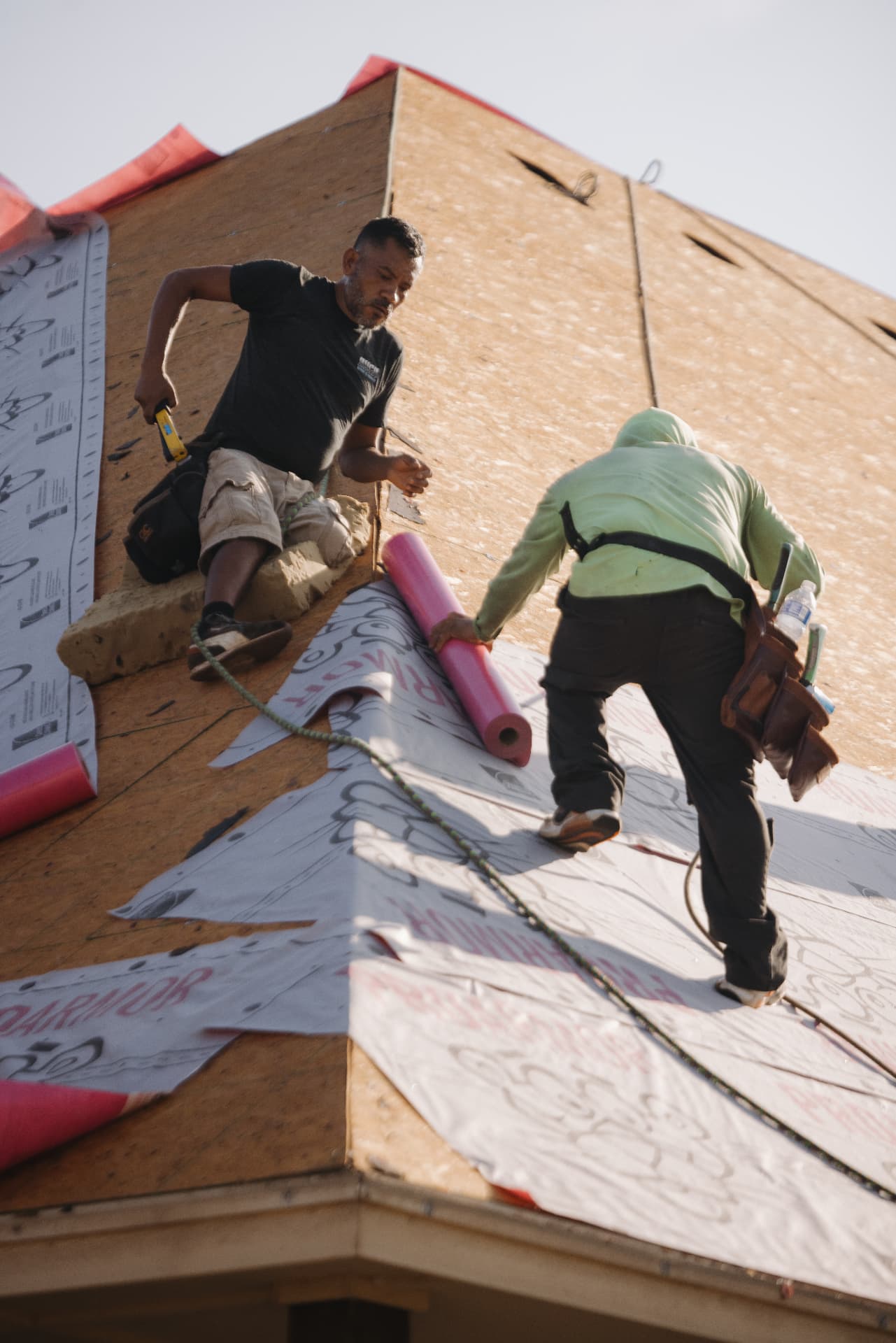 Rolling out underlayment across the decking