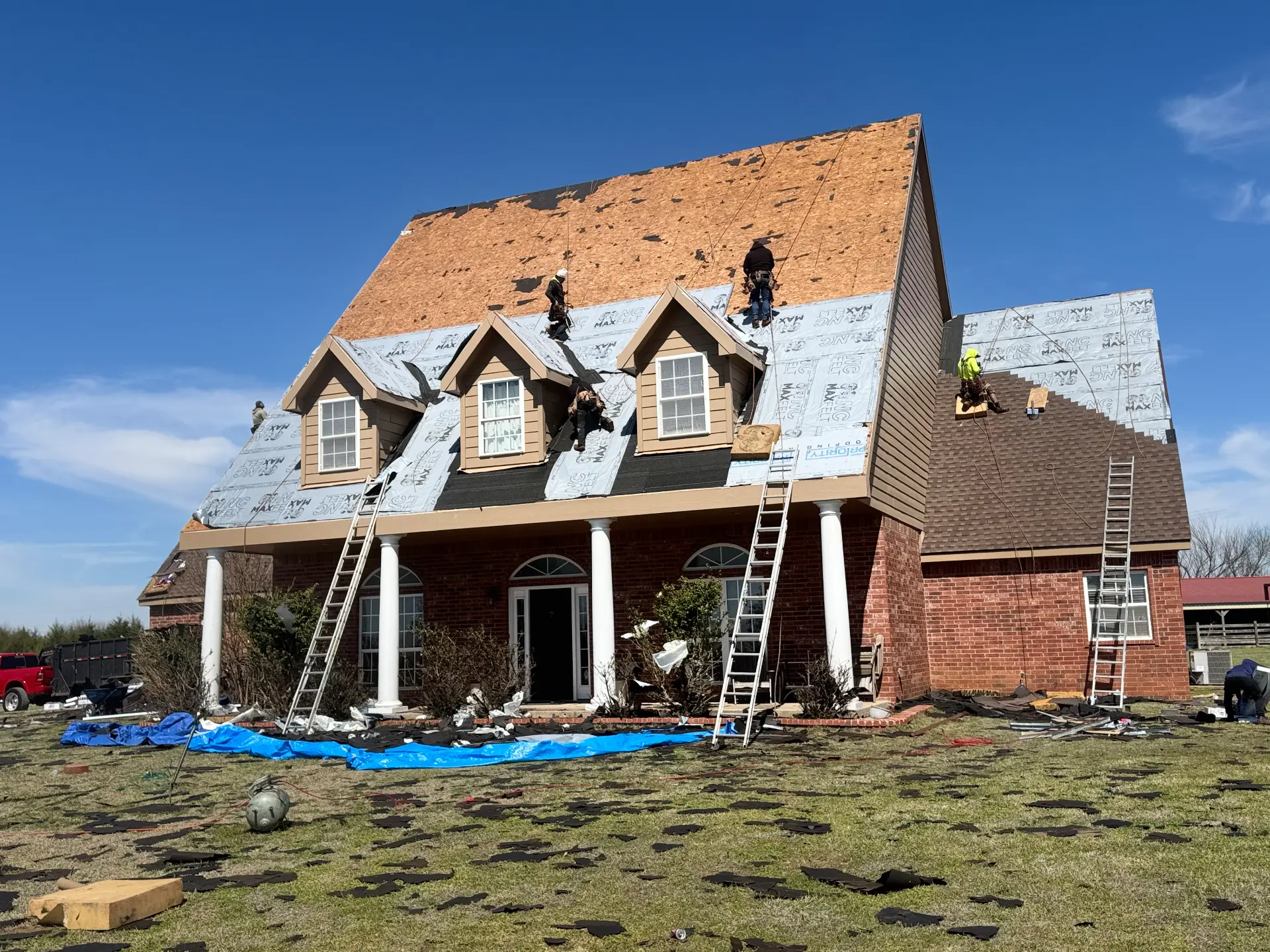 A large home with the decking exposed mid replacement