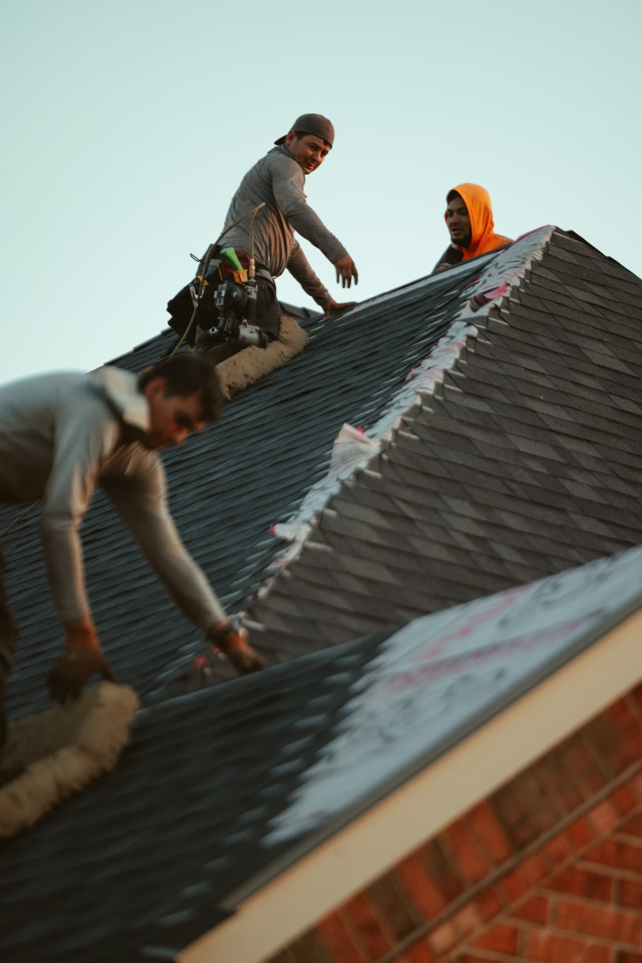 A&B crew installing shingles across a roof