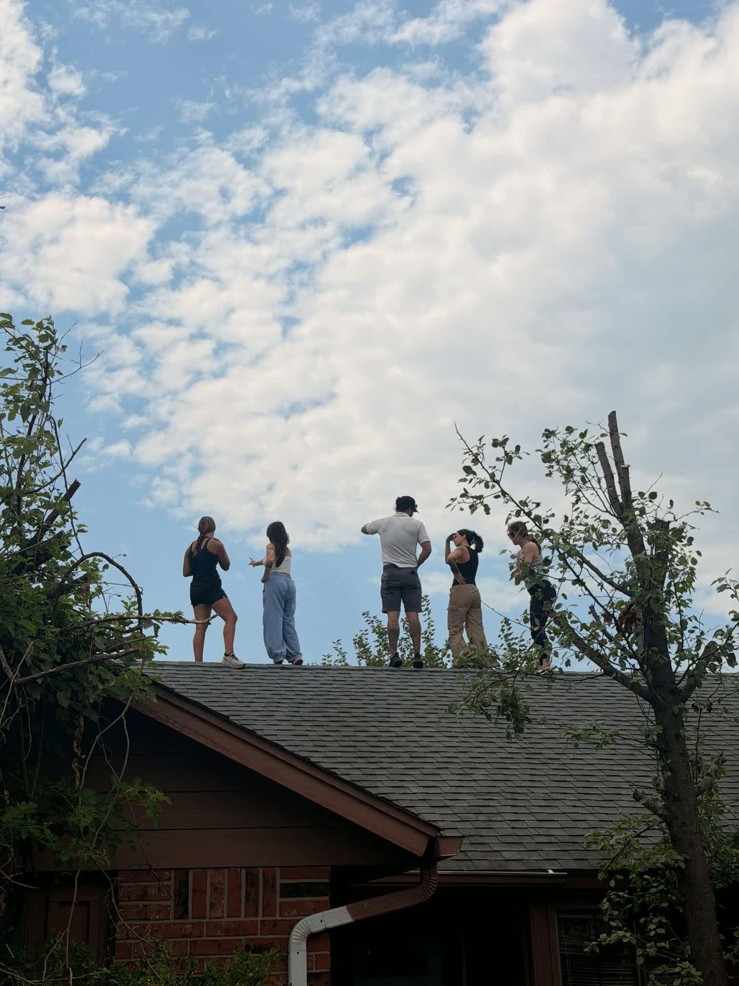 The crew walking a roof after storm damage