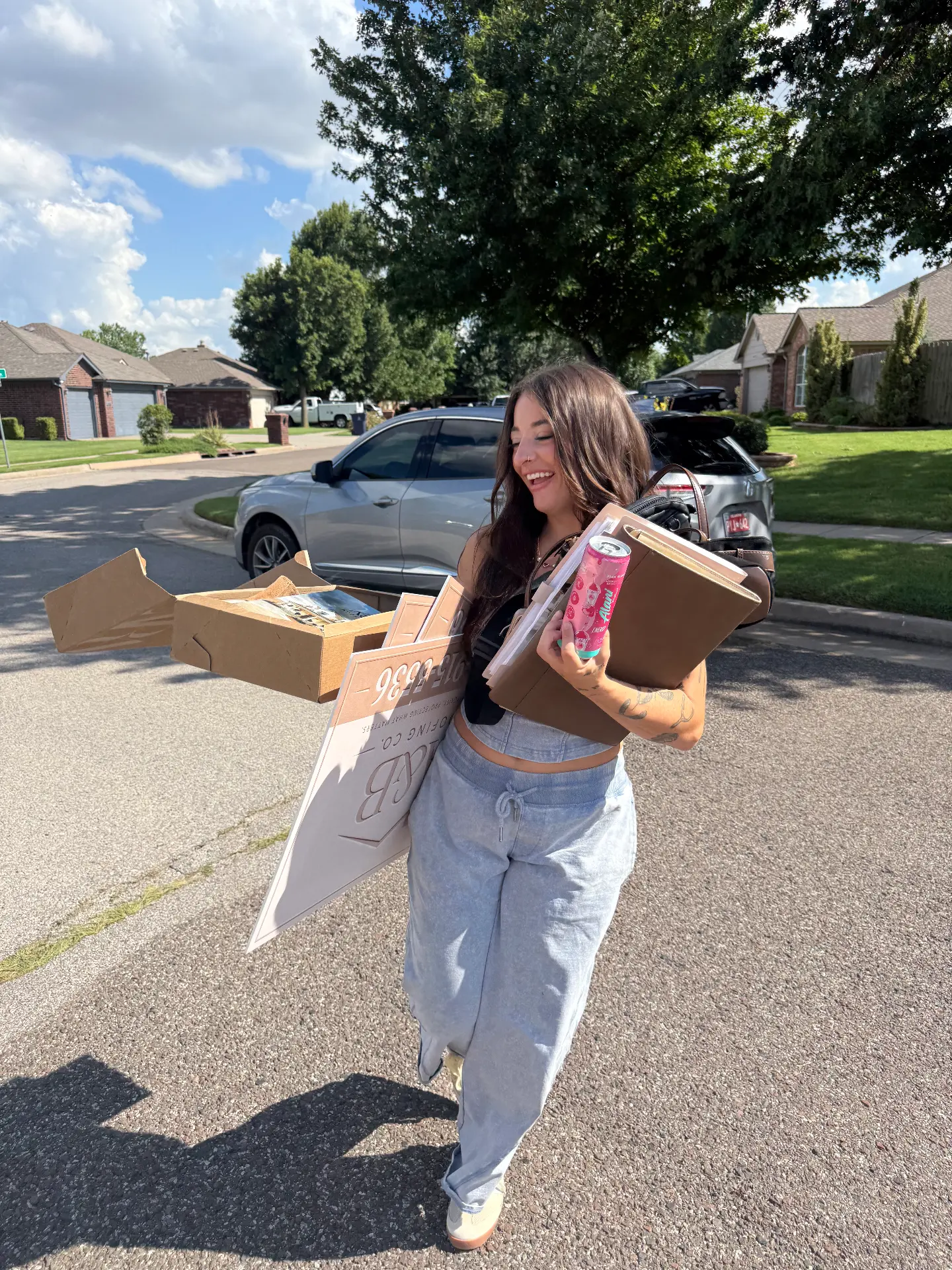 Carrying yard signs and folders down a neighborhood street