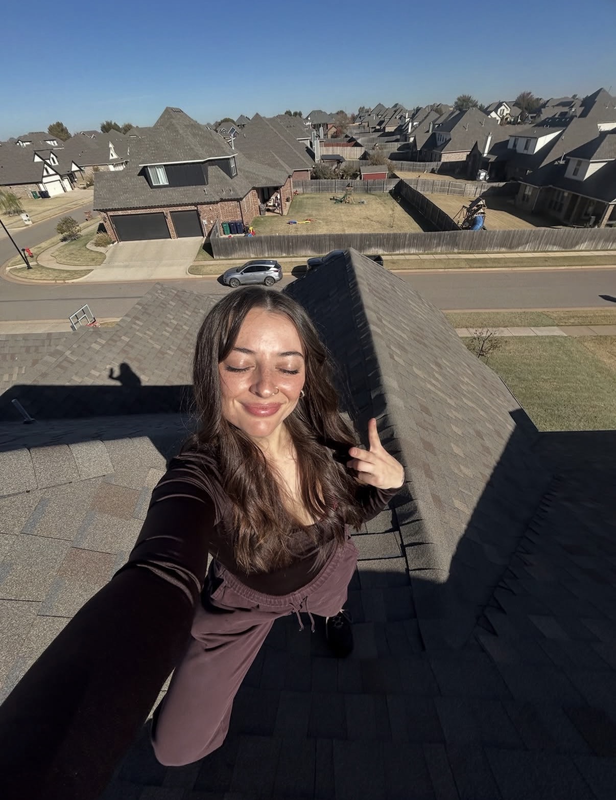 A thumbs up on a rooftop above the neighborhood