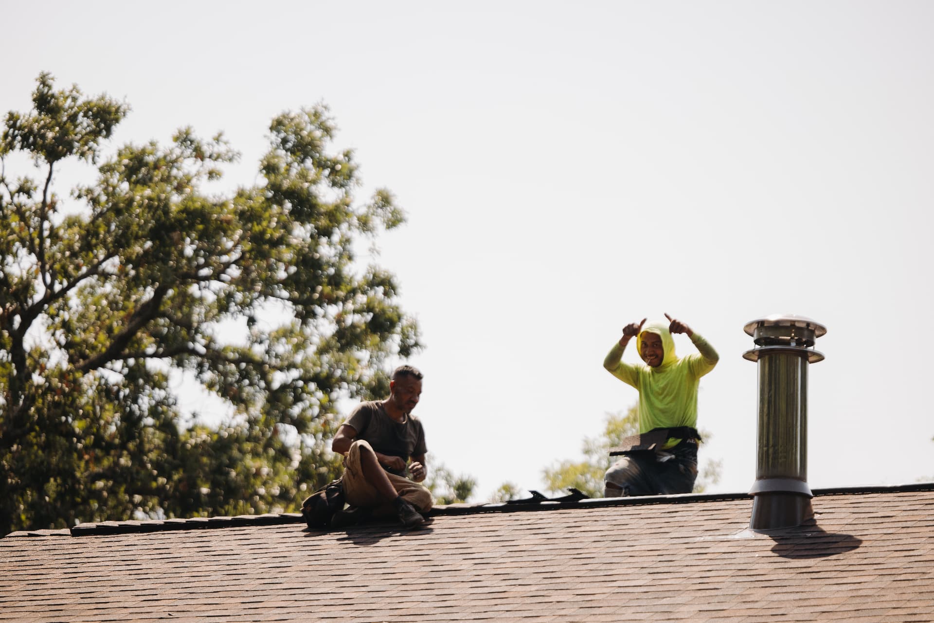 A crew member giving two thumbs up from the ridge