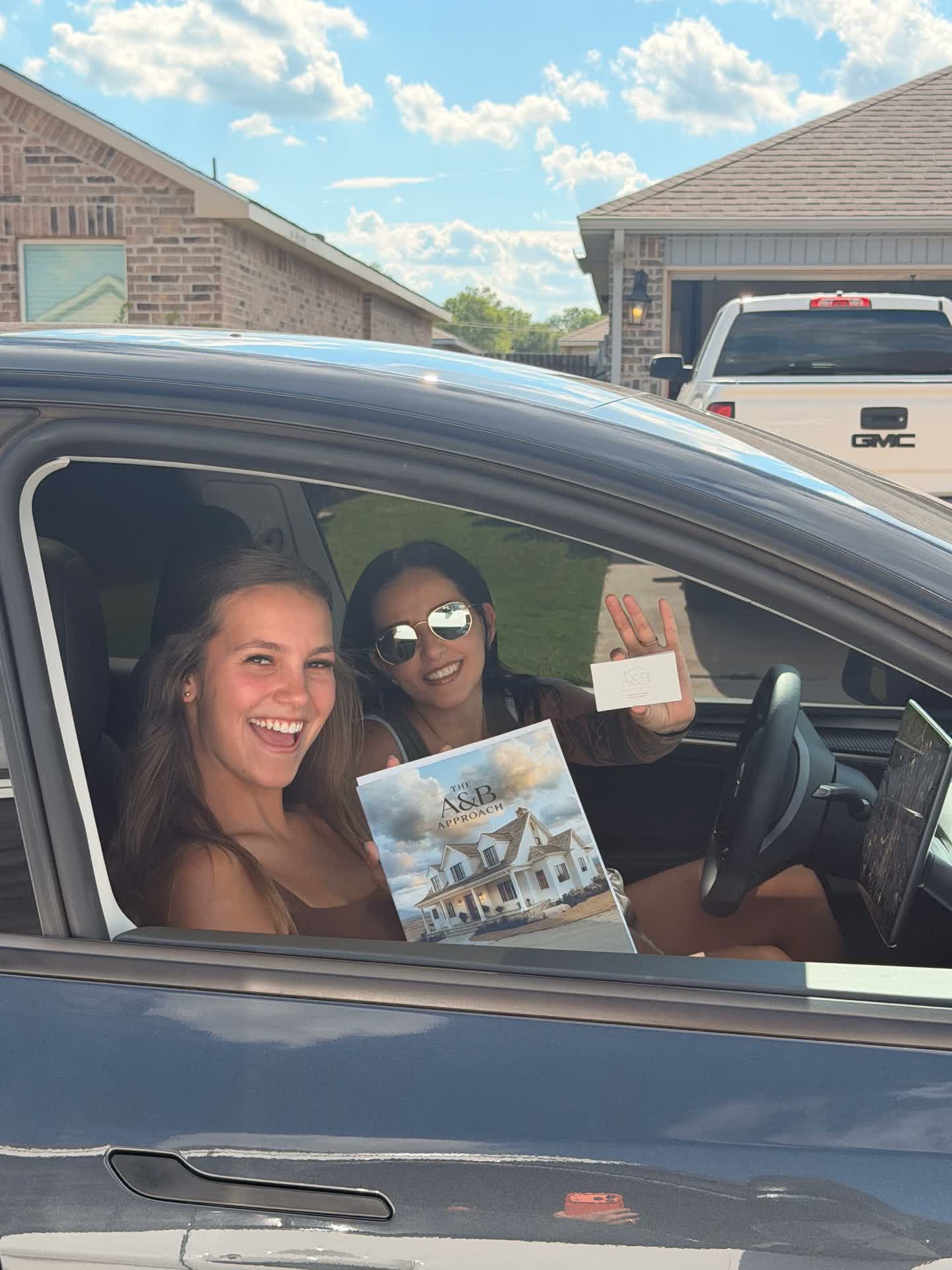 Team members holding The A & B Approach book on a neighborhood visit