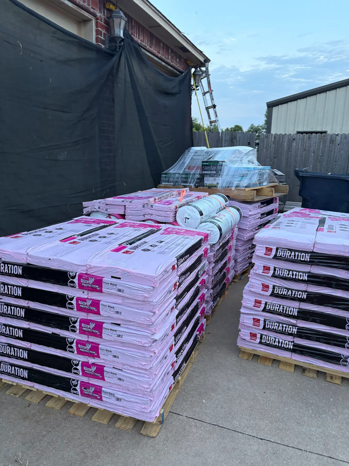 Pallets of shingles staged before a replacement